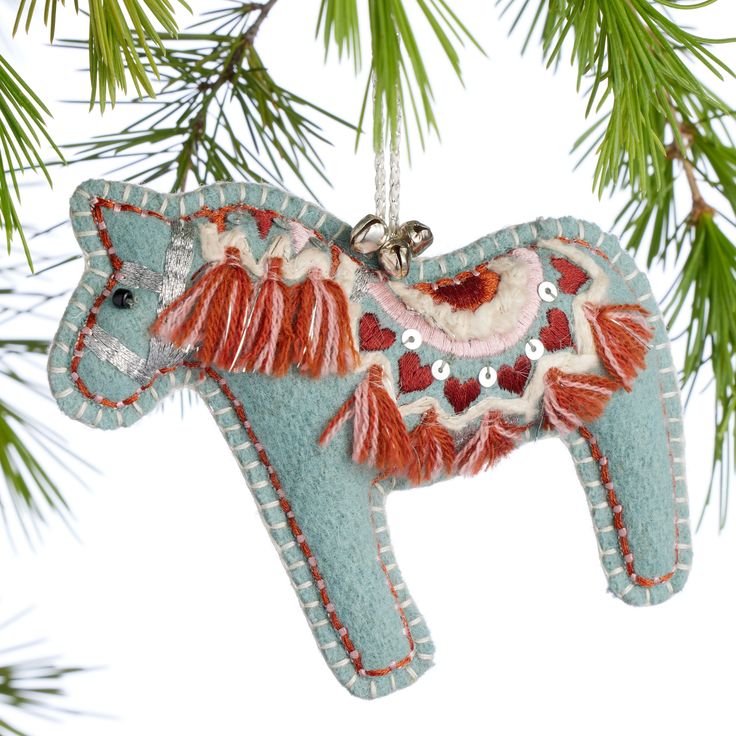 an ornament shaped like a horse hanging from a tree