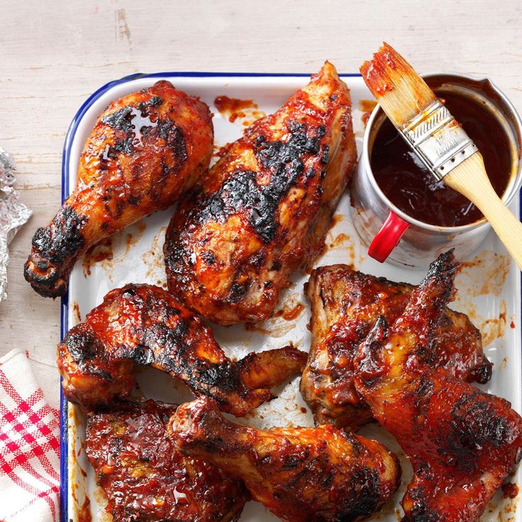 grilled chicken wings with bbq sauce and condiments on a tray, ready to be eaten