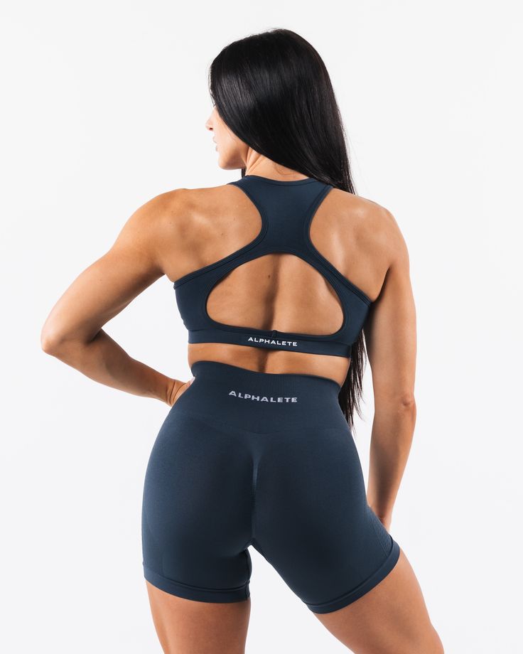 HIGHLIGHTS. Seamless construction Rib panel to contour and support Low to Medium impact Moisture-wicking breathable fabric Flattering scoop neckline A/B/C cup size FIT SUGGESTION. This item runs true to Alphalete's standard seamless fit.. We recommend sizing up for a comfortable fit.. Brooke is 5’5”/165cm, wearing a size S with a 35”/88.9cm bust. Hannah is 5'11/180.3cm, wearing a size L with a 42.5"/108cm bust. MATERIALS AND WASHING DIRECTIONS. 51% Polyamide, 38% Polyester, 11% Elastane. We reco Fitted Seamless Sports Bra With Scoop Back, Blue Seamless Sports Bra, Blue Racerback Sports Bra With Medium Bust Support, Blue Scoop Neck Sports Bra For Athleisure, Blue High Stretch Seamless Sports Bra, Blue Athleisure Sports Bra With Scoop Neck, Athleisure Blue Scoop Neck Sports Bra, Blue Seamless Scoop Neck Sports Bra, Blue Medium Support Sports Bra With Scoop Neck