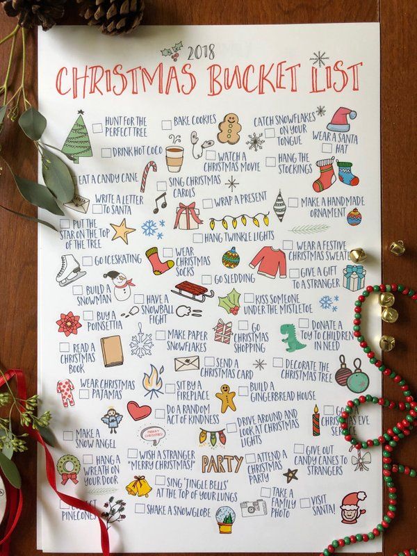 a christmas bucket list is shown on a table