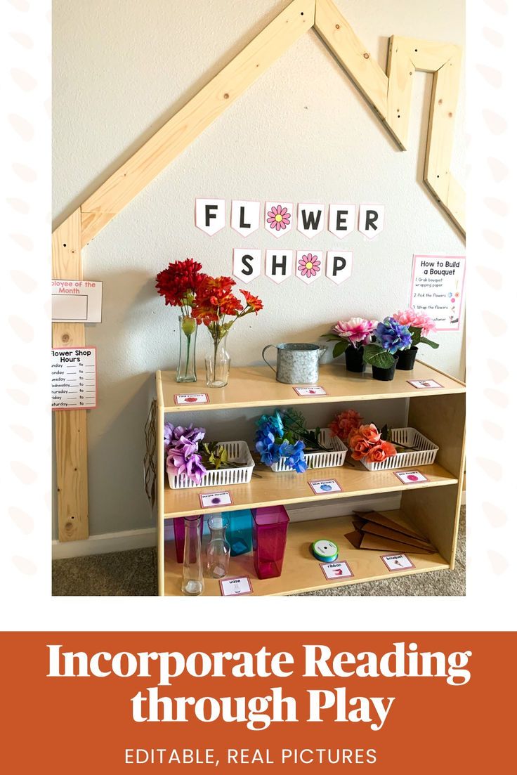 a shelf with flowers and cards on it in front of a sign that reads, incorporating reading through play