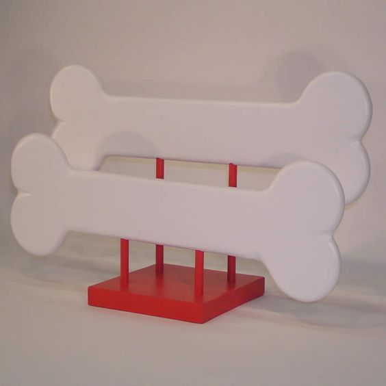 a red and white dog bone stand on a white background