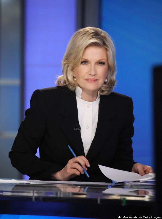 a woman sitting at a desk with a pen and paper in front of her on tv