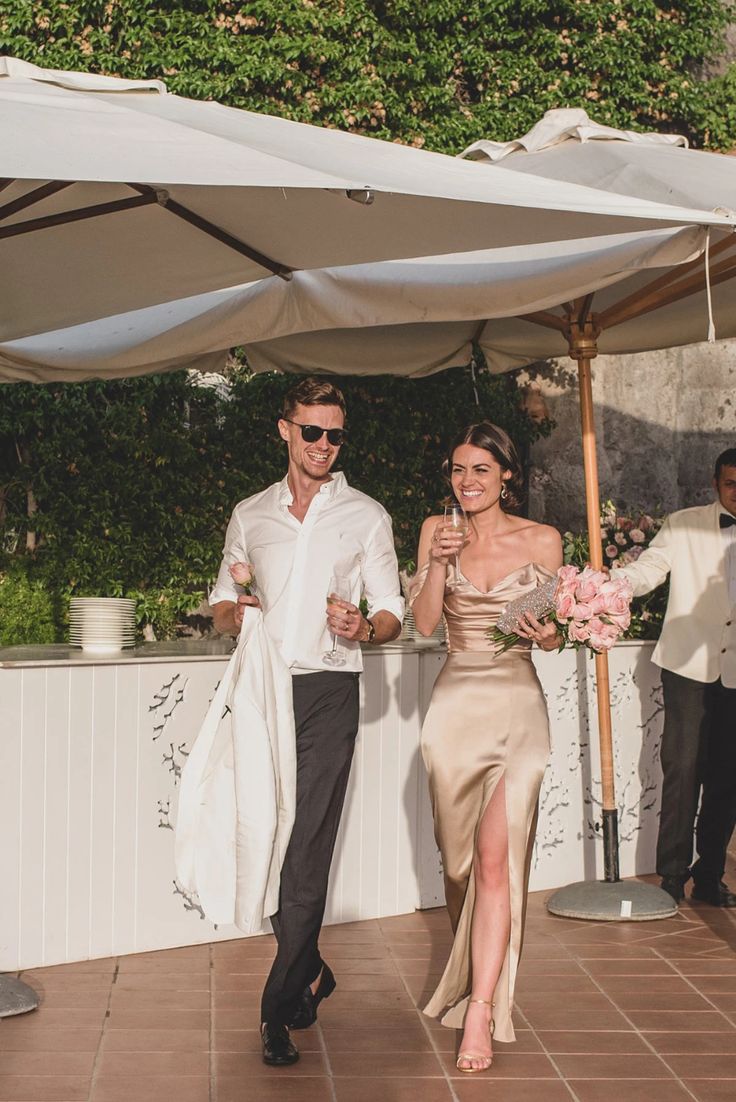 a man and woman walking under an umbrella