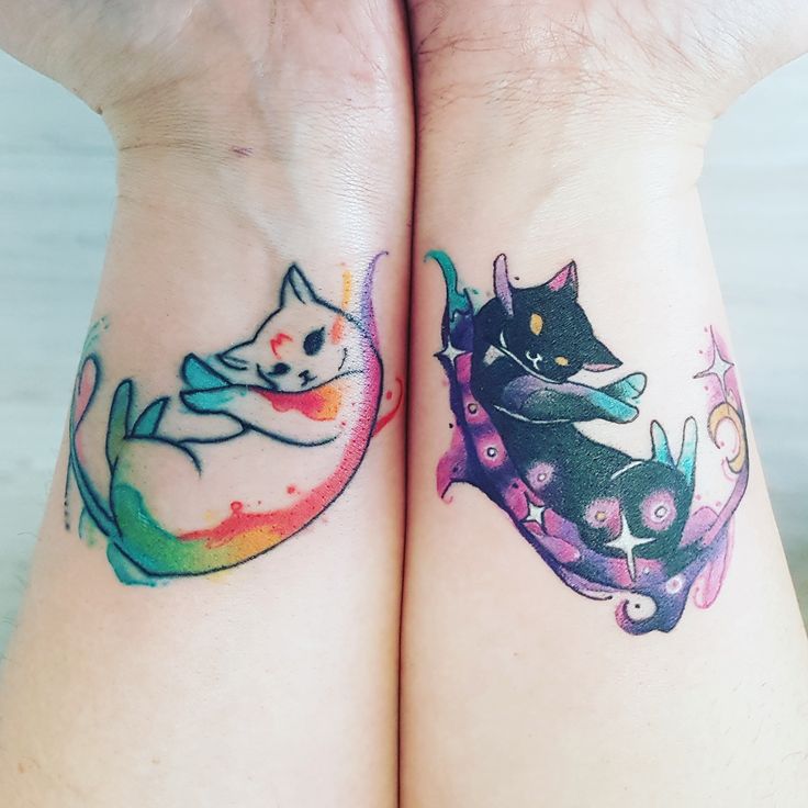 two cats tattoo on both wrist and arm, one with a cat sitting on the other