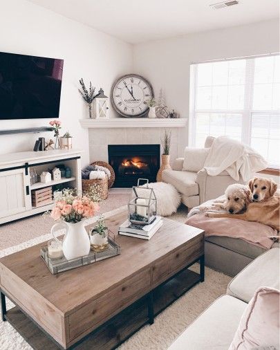 a living room filled with furniture and a flat screen tv mounted on the wall above a fire place