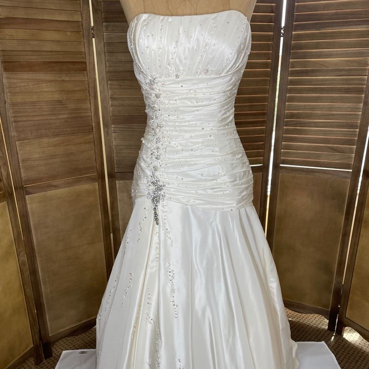 a white wedding dress on display in a store