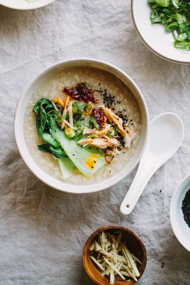 a bowl of oatmeal with spinach and other ingredients