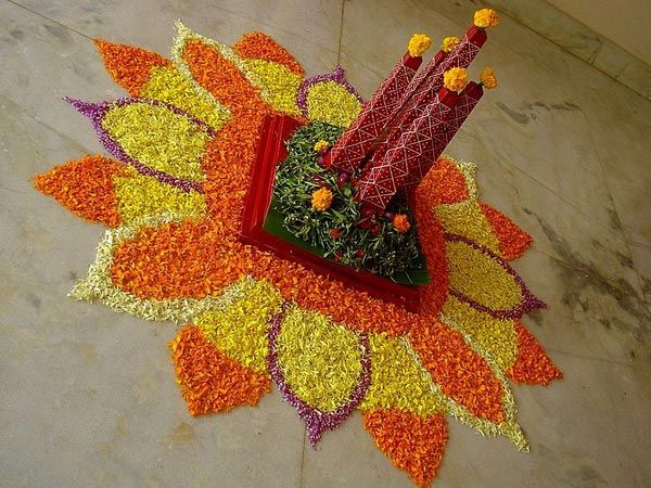 an arrangement of flowers is placed on the floor