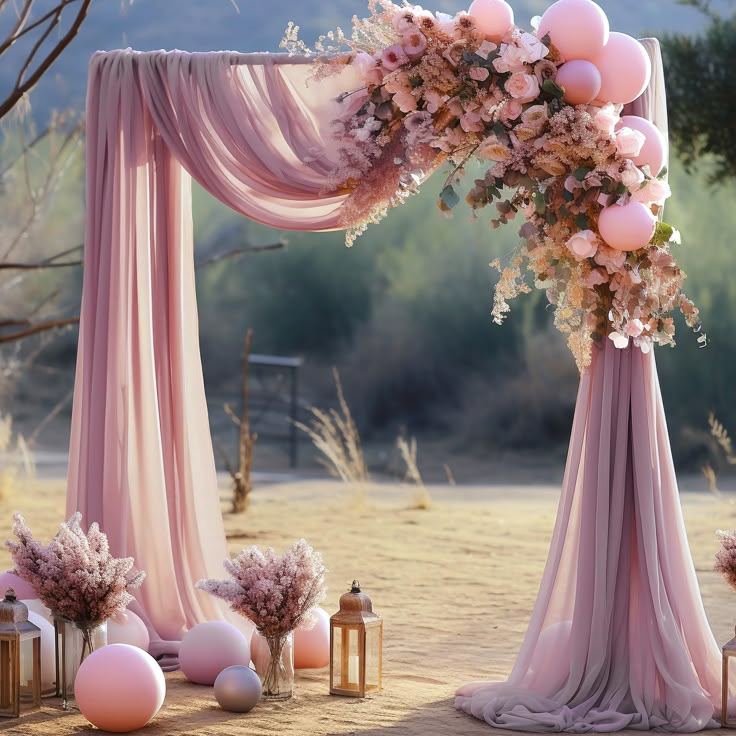 an outdoor wedding setup with pink flowers and balloons