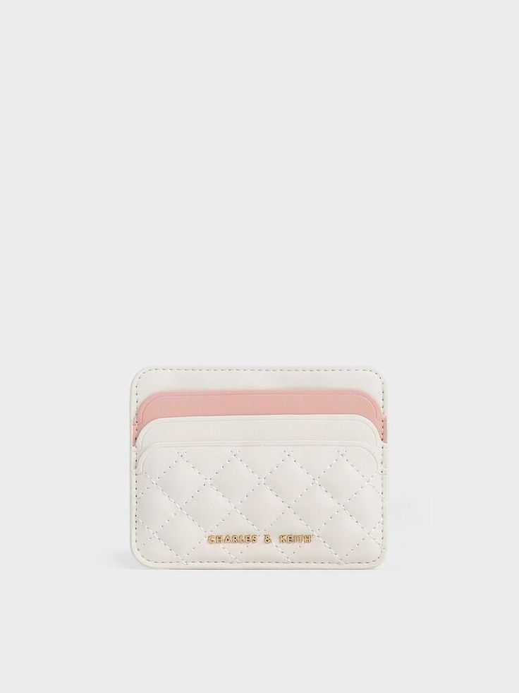 This product is made with at least 20% sustainable materials by weight. CHARLES & KEITH uses recycled, degradable, organic, and water-based materials in our eco-conscious collection. Small but mighty, this cardholder is perfect for the modern woman. Featuring a two-toned finish that accentuates elegant cream with a pink accent, this cardholder exudes classic femininity. The quilted texture adds a luxurious element to the simple design, along with a charming tactility. Offering the functionality of six card slots and one middle compartment for loose change or bills, it will hold your valuables while being compact enough to fit in your smaller bags. Aesthetic Shoulder Bag, Simple Wallet, Luxury Bags Collection, Small But Mighty, Charles Keith, Pink Accents, Card Holder Wallet, Sustainable Materials, Eco Conscious