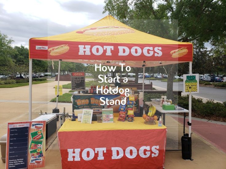 a hot dog stand is set up on the side of the road for people to eat