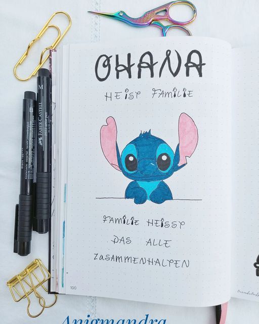 an open notebook with the words ohana written on it next to some office supplies