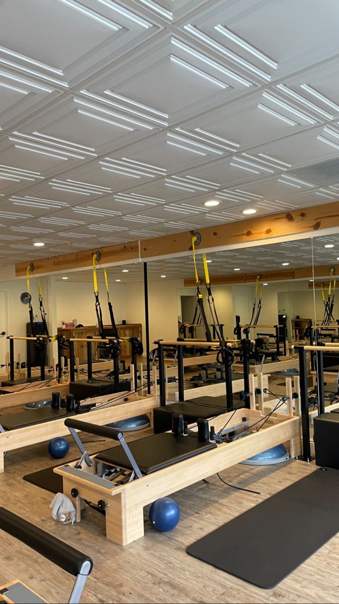 an empty gym with exercise equipment and mirrors