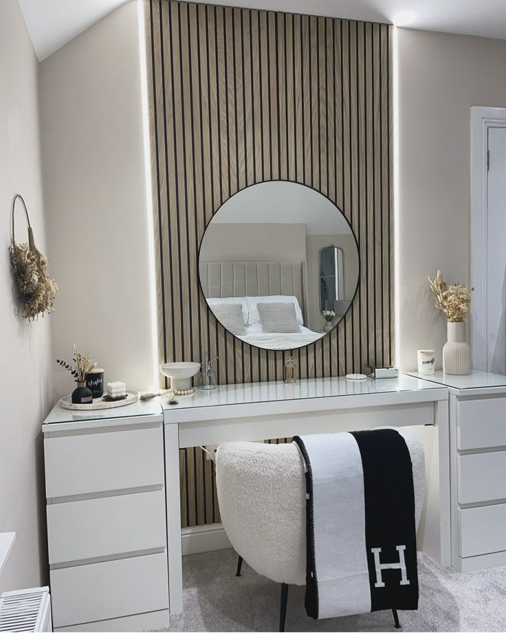 a bedroom with a vanity and mirror in it