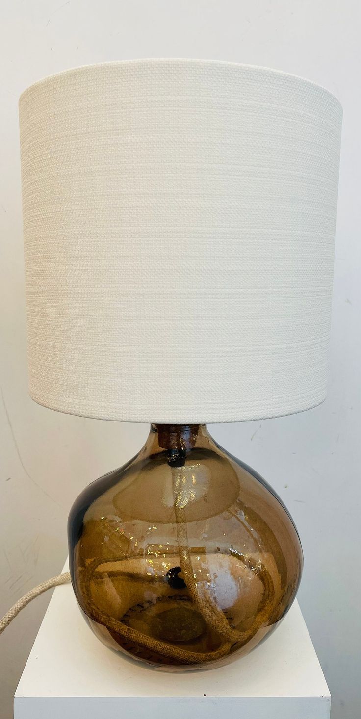 a lamp that is sitting on top of a white box with a light in it