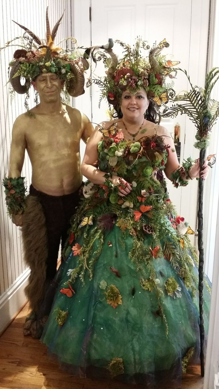 a man and woman are dressed up in costumes made out of flowers, leaves and plants