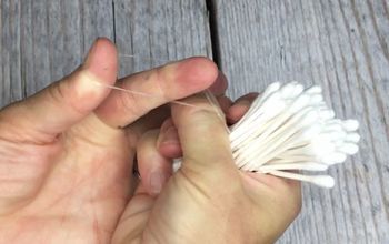 a person is holding some white yarn in their hand