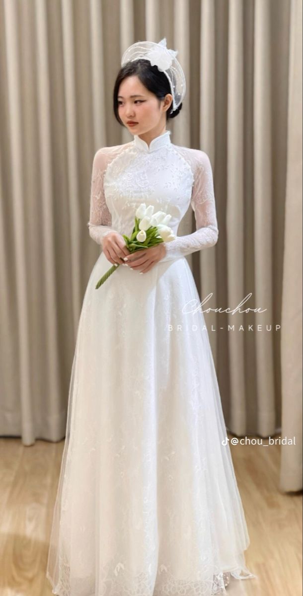 a woman in a white wedding dress holding a bouquet