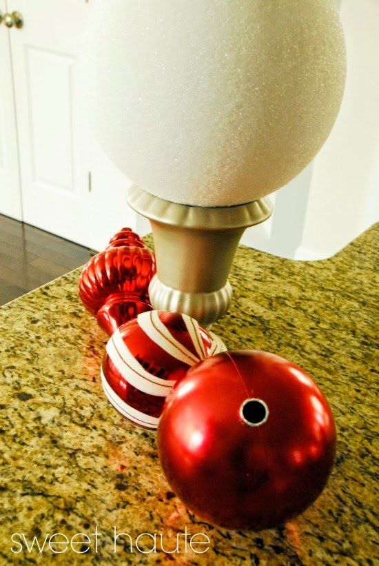 a red bowling ball sitting on top of a counter next to a white light fixture