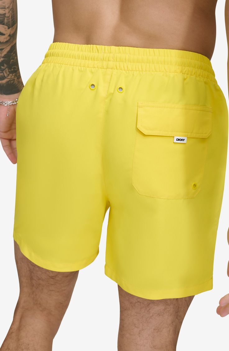 Soak up the sun in these recycled-fiber swim trunks built with UPF 40+ sun protection. 5" inseam (size Medium) Elastic/drawstring waist Front slant pockets; back patch pocket Lined 100% REPREVE polyester REPREVE recycled polyester is made from 100% post-consumer recycled plastic bottles Machine wash, tumble dry Imported Yellow Swim Trunks For Summer Beach, Short Swimwear For Beach Season, Solid Color Swim Trunks With Pockets For Pool, Solid Nylon Swim Trunks For Beach Season, Solid Swim Trunks With Pockets For Pool, Nylon Swim Trunks For Beach In Warm Weather, Yellow Summer Swim Trunks For Vacation, Nylon Swimwear With Pockets For Summer, Swim Trunks With Pockets For Pool