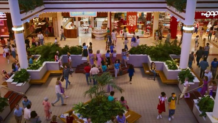 an overhead view of a mall with people walking around and shops on the other side