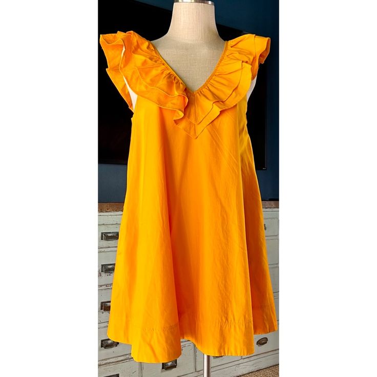 New With Tags Size Small This Flirty Mini Dress By Maeve At Anthropologie Is A Golden Yellow Color. The 100% Cotton Dress Is Fully Lined & Has Pockets. The Dress Has A Flattering V-Neck Covered In A Ruffle That Extends To The Back. The Back Has A Criss Cross Design. It Has A Loose Tunic Shape. Measurements Laying Flat: Length 33 3/4” Bust 19 3/4” Waist 24 1/4” Hips 27” Yellow Ruffle Dress For Spring, Yellow Ruffled Dress For Spring, Spring Yellow Ruffled Dresses, Yellow Ruffled Dresses For Summer, Yellow Ruffled Knee-length Midi Dress, Yellow A-line Midi Dress With Ruffles, Yellow Ruffled Sundress For Summer, Yellow Ruffled Summer Dress, Yellow Summer Dress With Ruffles