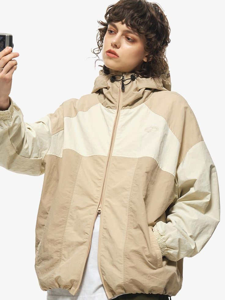 Jacket designed by CPGN. Unique and comfortable item that is good to have as a light outer. Recommend having this as a casual wear or even suitable for light activities.  - Oversized fitting silhouette- Hoodie with adjustable string and stopper- 2-way zip-up closure- Banded cuff detail- Adjustable hem with string and stopper Casual Beige Long Sleeve Windbreaker, Beige Long Sleeve Casual Windbreaker, Beige Long Sleeve Windbreaker For Outdoor, Oversized Beige Windbreaker With Long Sleeves, Oversized Beige Casual Windbreaker, Oversized Beige Long Sleeve Windbreaker, Casual Beige Track Jacket For Spring, Beige Windbreaker With Pockets For Streetwear, Beige Parka For Outdoor Activities