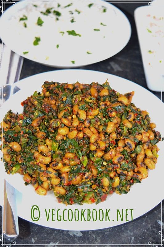 a white plate topped with beans and greens