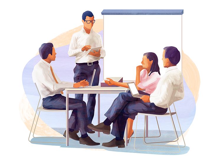 a group of people sitting around a table with a white board in front of them