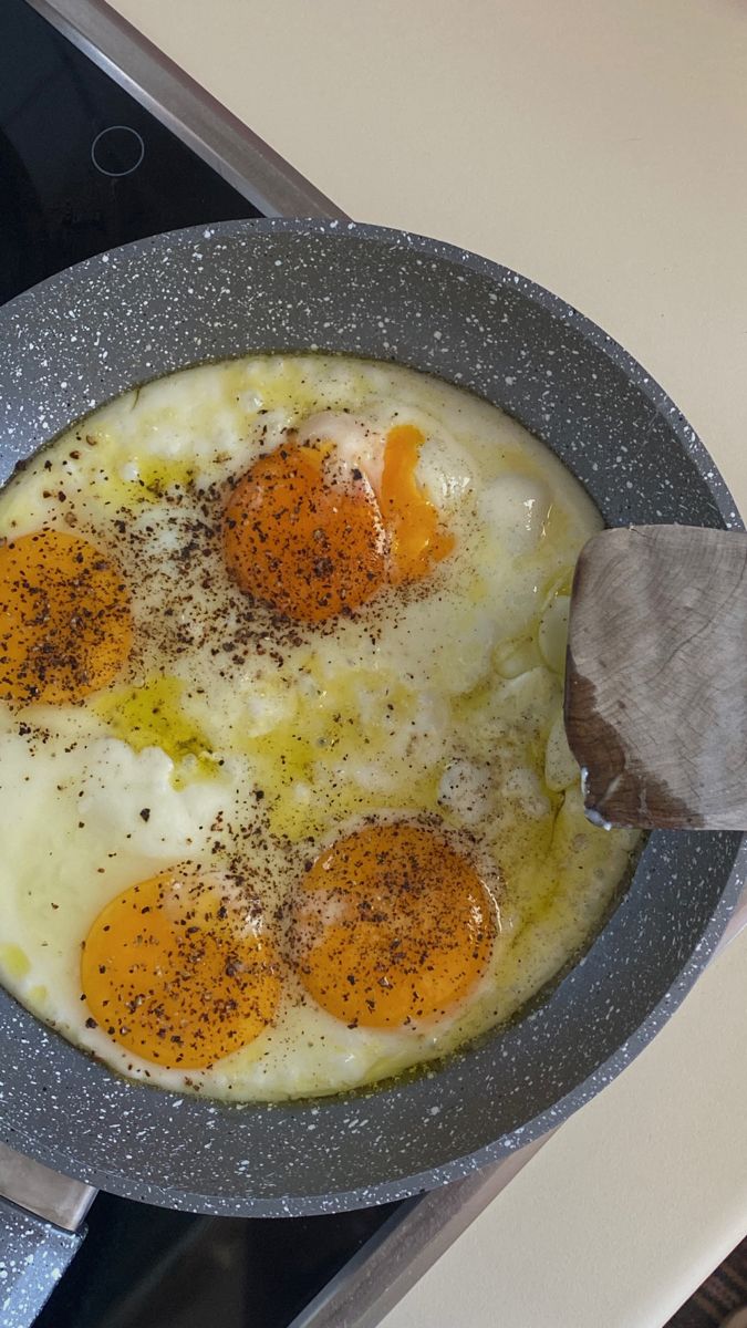 an egg frying pan with three eggs in it