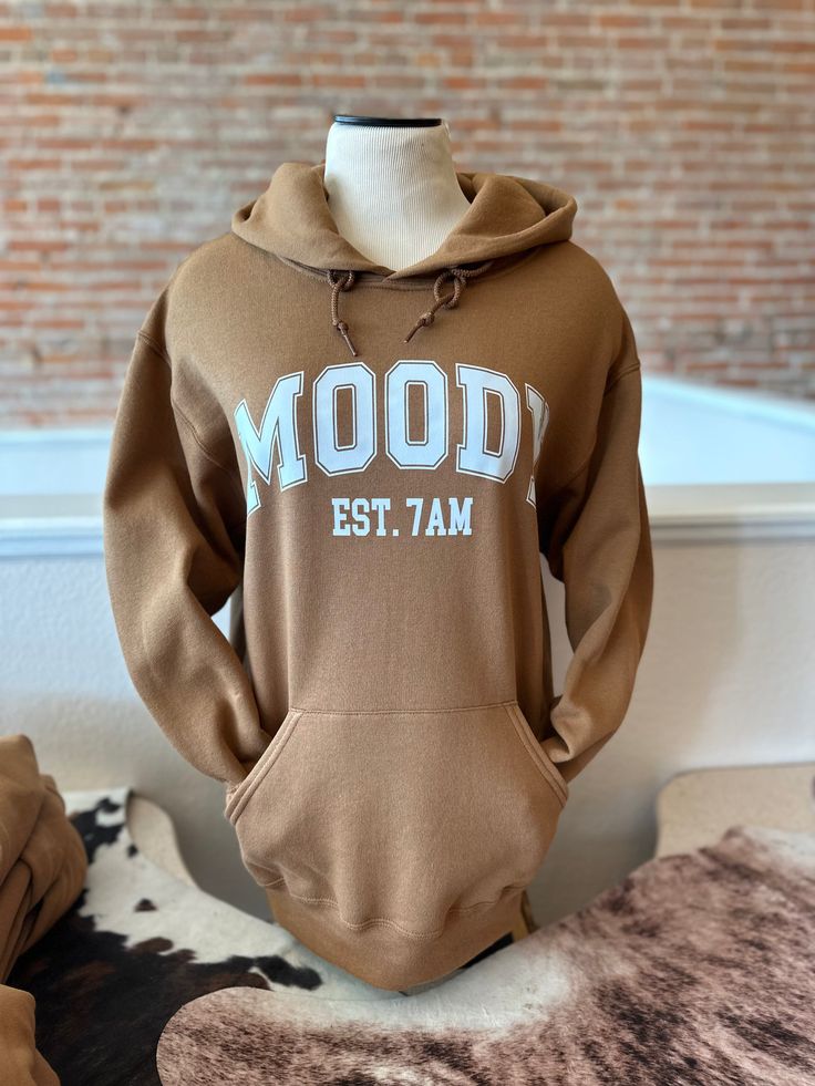 The Moody hoodie is the perfect choice for those who aren't morning people. Featuring a unisex fit and soft, cozy material in a chestnut brown color, this hoodie provides comfort and style. Whether you’re working from home or going out, the Moody hoodie will keep you warm and feeling stylish. Brown Cotton Hoodie For Loungewear, Brown Cotton Hoodie With Kangaroo Pocket, Brown Cotton Hoodie With Adjustable Hood, Brown Cotton Sweatshirt With Adjustable Hood, Brown Hoodie With Drawstring For Loungewear, Brown Crew Neck Sweatshirt With Kangaroo Pocket, Brown Sweatshirt With Kangaroo Pocket For Loungewear, Brown Drawstring Hood Sweatshirt For Loungewear, Brown Hoodie With Adjustable Hood And Relaxed Fit