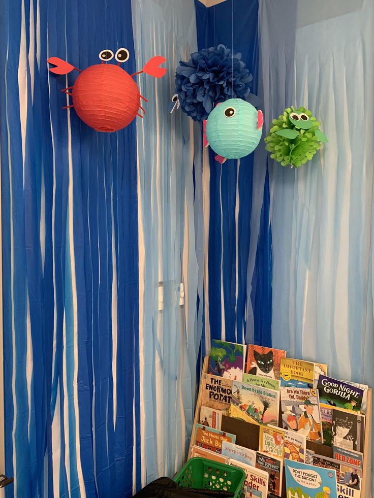 a room decorated with blue streamers and paper decorations