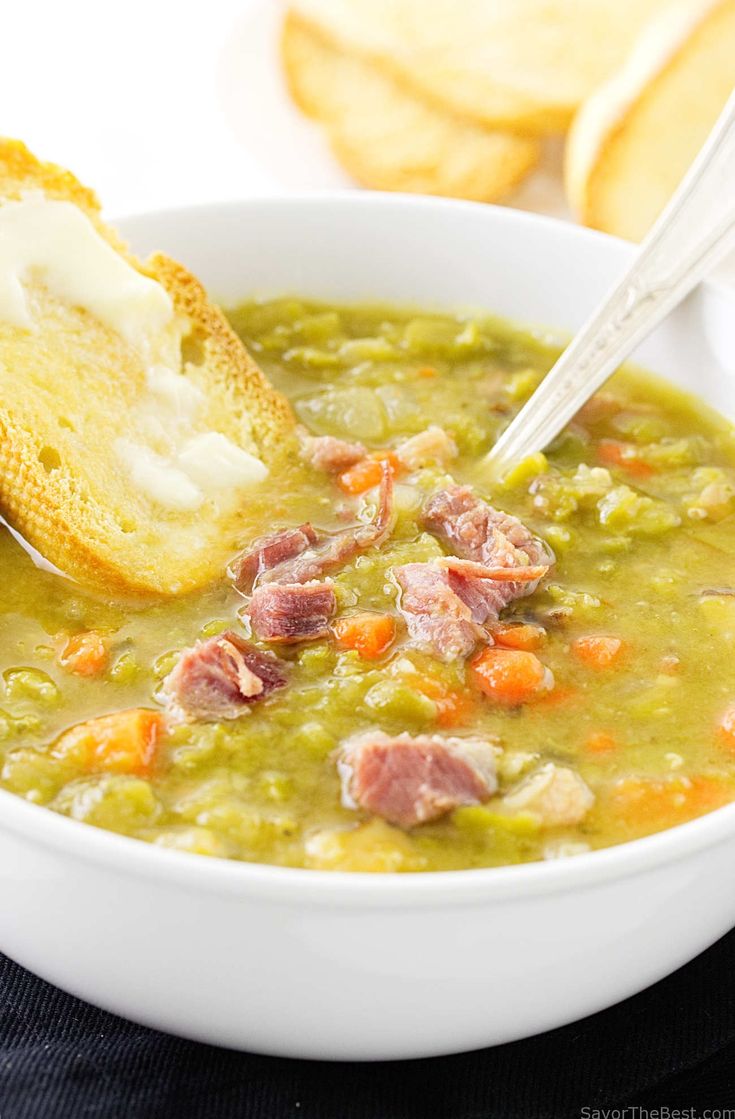 a white bowl filled with soup and bread