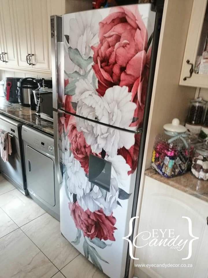 a refrigerator decorated with flowers in a kitchen