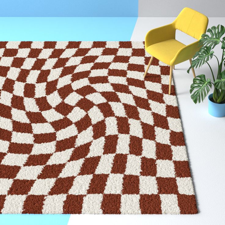 a room with a rug, chair and potted plant