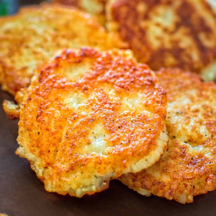 three crab cakes sitting on top of a wooden cutting board