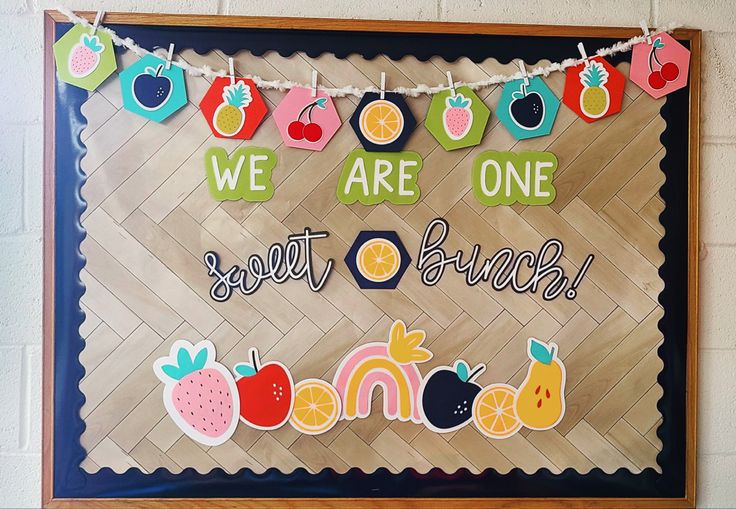 a bulletin board with fruit and words on it that says we are one sweet bunch