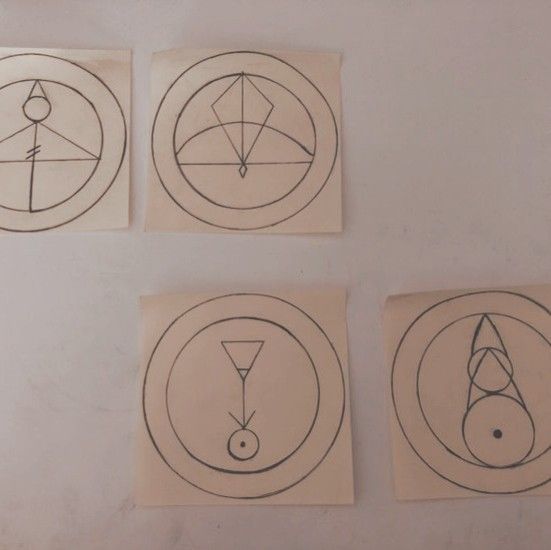 four circular drawings are shown on the wall