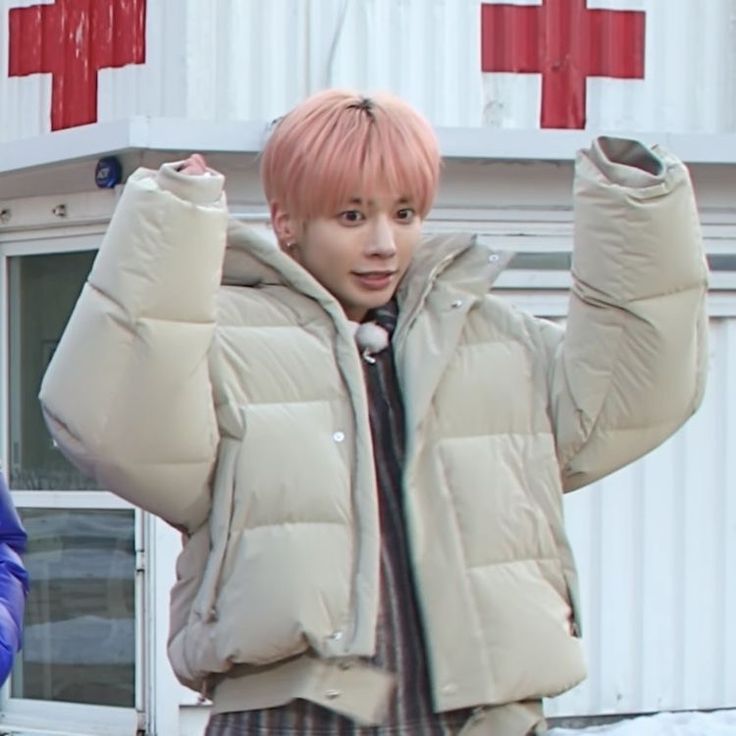 a young man with pink hair wearing a puffy jacket