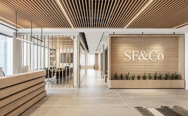 the interior of a modern office building with wood slats on the wall and planters