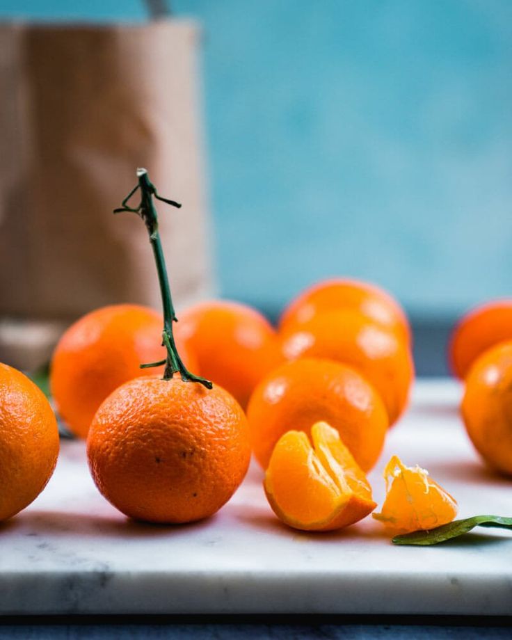 several oranges are arranged on a counter top