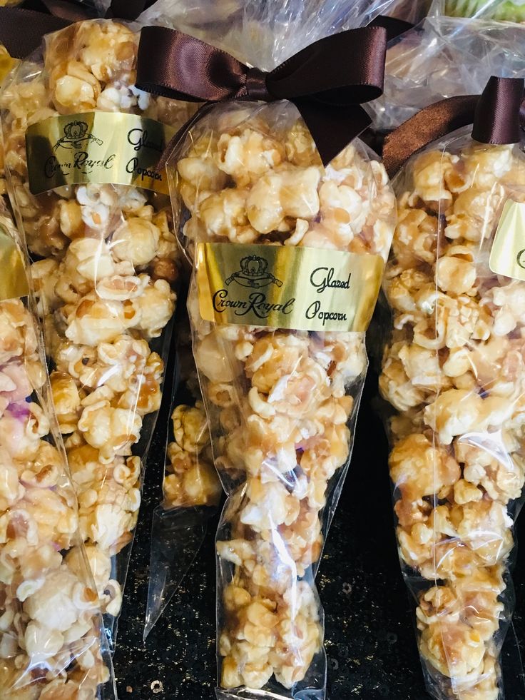 several bags filled with popcorn sitting on top of a black counter next to each other