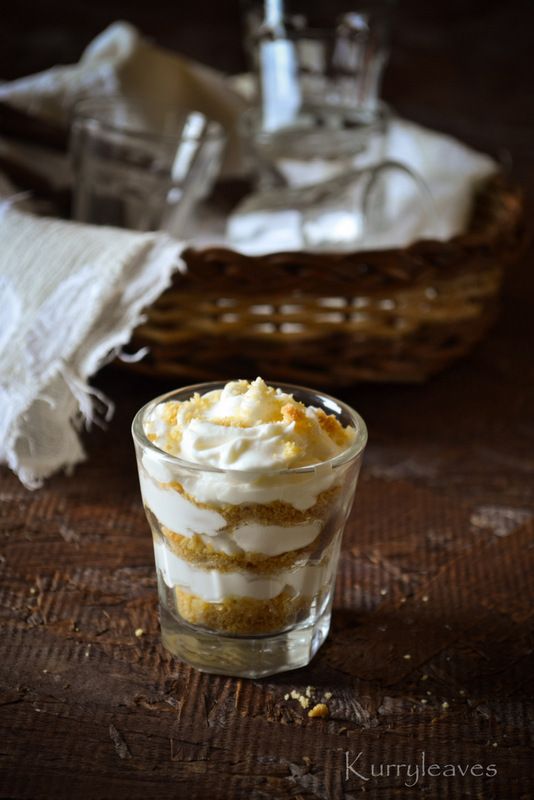 a small glass filled with dessert sitting on top of a table