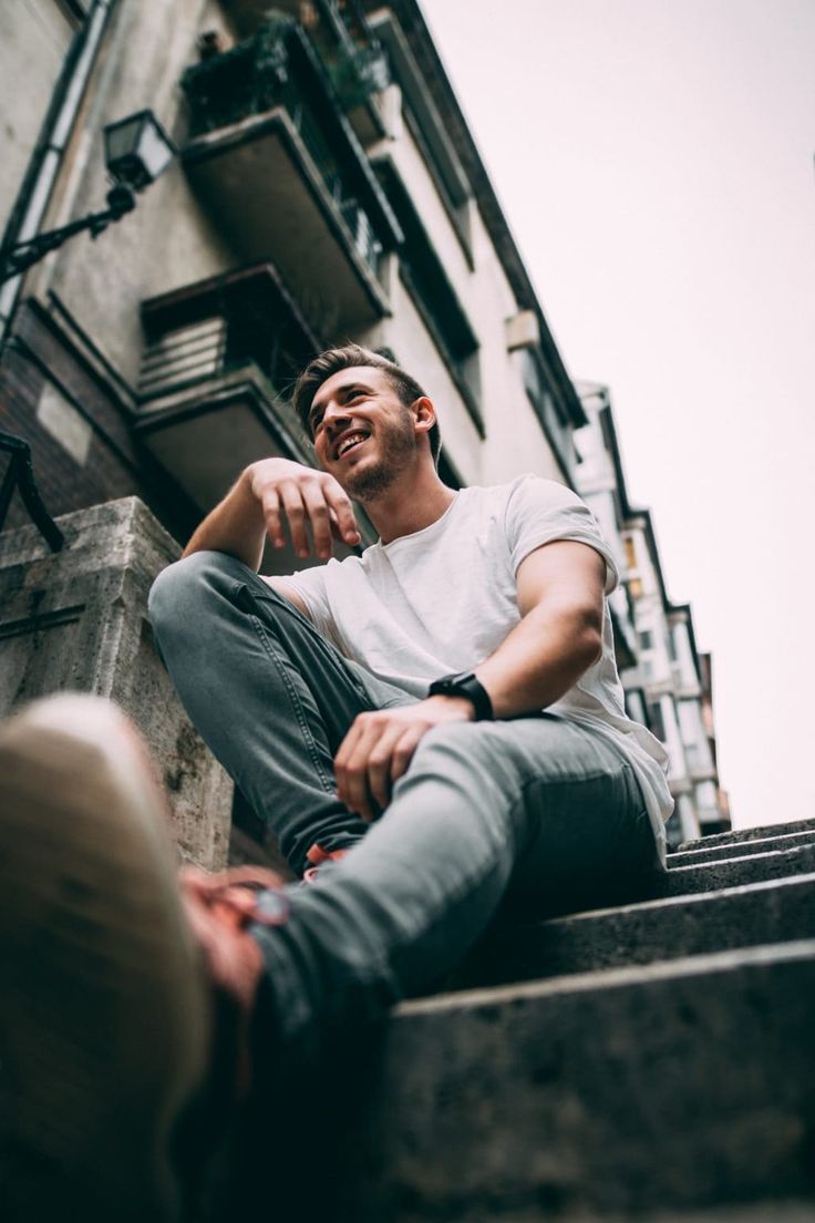 a man is sitting on the steps outside