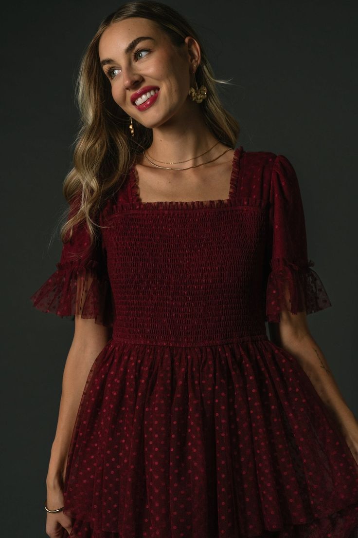 Baltic Born exclusive style Perfect special occasion dress Swiss dot tulle overlay Beautiful Burgundy color Straight cut neckline, overlapping bodice with small tulle ruffle Short sleeve with tulle ruffle detail at cuff Smocked bodice Natural waist with elastic Midi Length skirt with three tiers Fully lined Casey is 5'8, cup size 32B, size 2 and wearing size S Marianne is 5'6, cup size 34D, size 6 and wearing size S Party Dress With Smocked Bodice And Short Sleeves, Fitted Tulle Dress With Ruched Detail, Fitted Ruched Tulle Dress, Party Mini Dress With Smocked Bodice And Short Sleeves, Short Sleeve Mini Dress With Smocked Bodice For Party, Ruched Tulle Dress With Fitted Bodice, Chic Short Sleeve Tulle Dress, Fitted Swiss Dot Square Neck Dress, Fitted Swiss Dot Dress With Square Neck