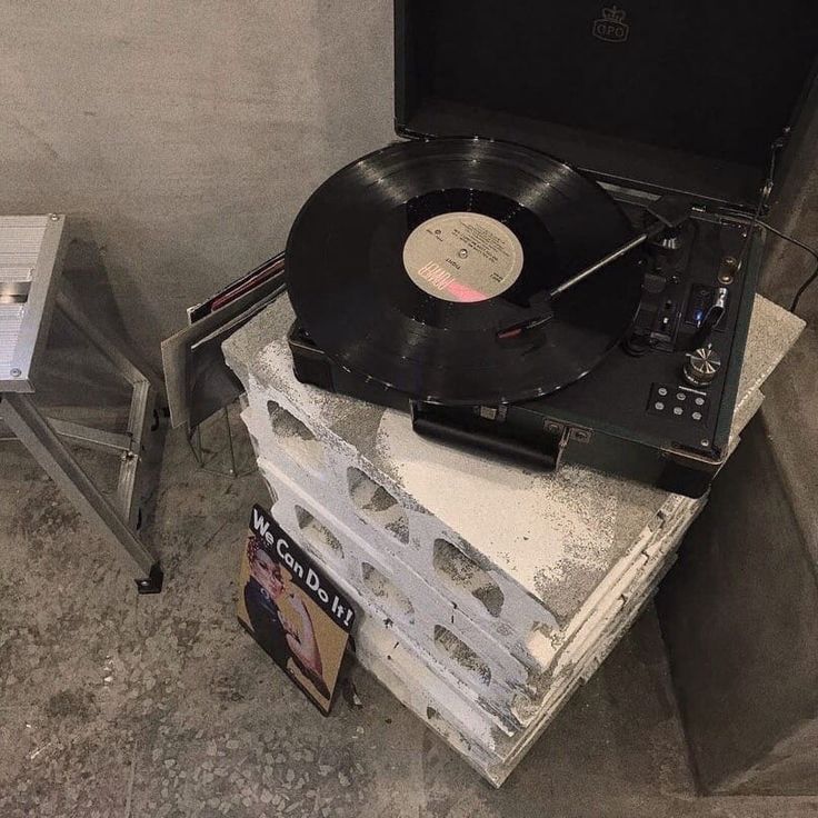 an old record player sitting on top of a table