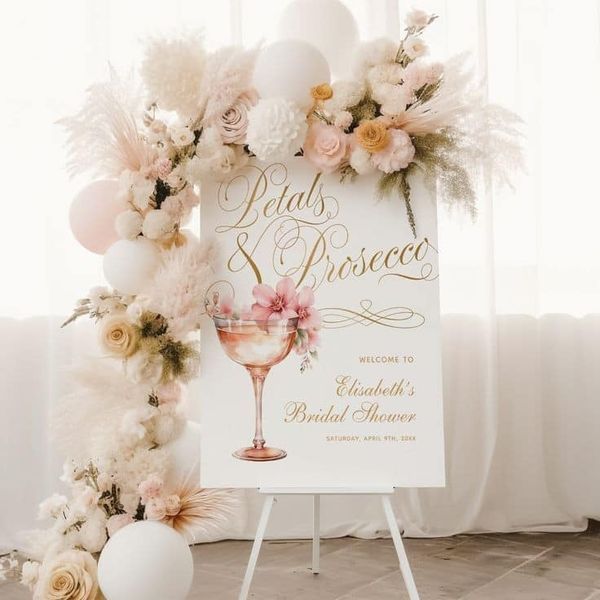 a sign that is on top of a stand with flowers and balloons in the background