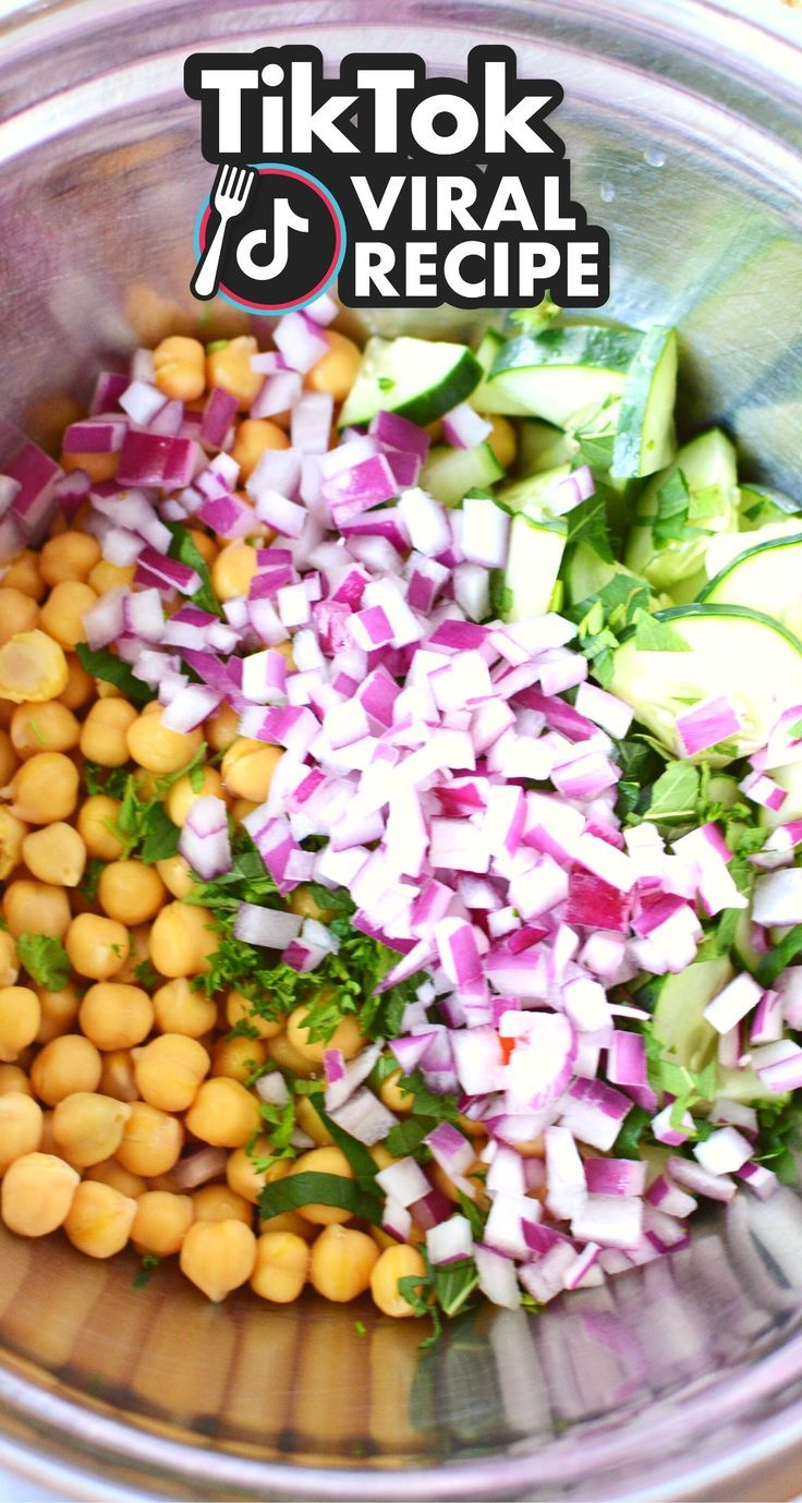 a bowl filled with chopped vegetables and chickpeas