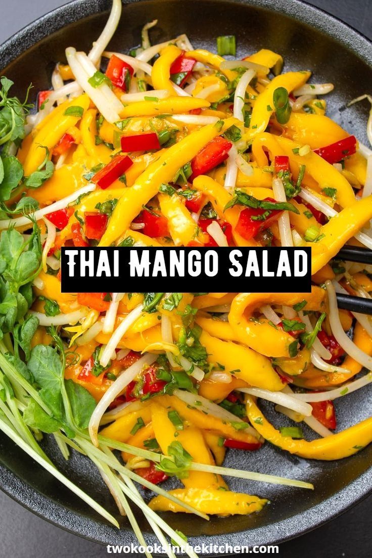 thai mango salad in a skillet with the words, thai mango salad on top